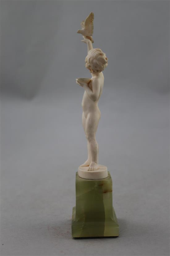 Ferdinand Preiss (German, 1882-1943). An Art Deco carved ivory figure of a young girl feeding a bird, 7.5in.